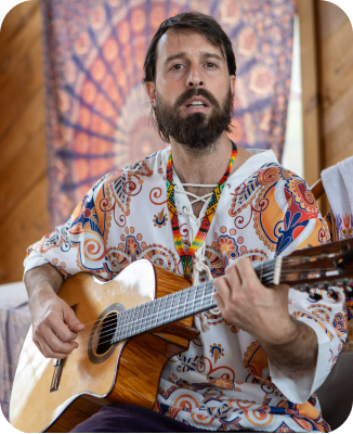 The person is depicted in a setting commonly used for sacred song circles or prayer gatherings