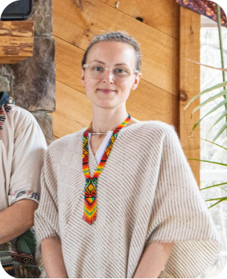This image shows a lady wearing a beige and white striped woolen poncho.
