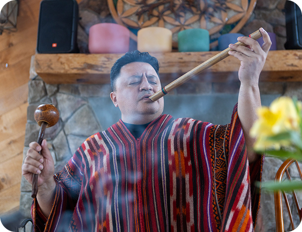 This image shows a Peruvian shaman performing a cleansing ceremony.