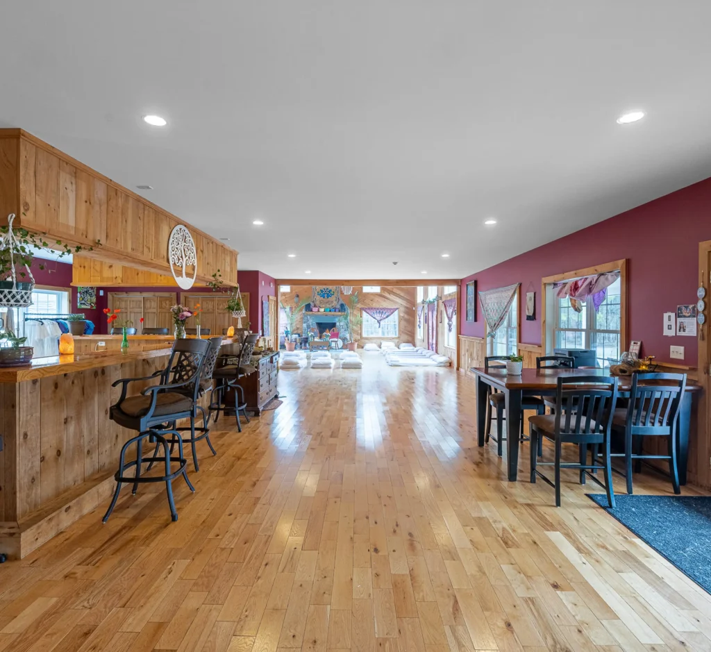 The retreat center includes a cozy environment with windows for natural light and acoustics suitable for live music during ceremonies
